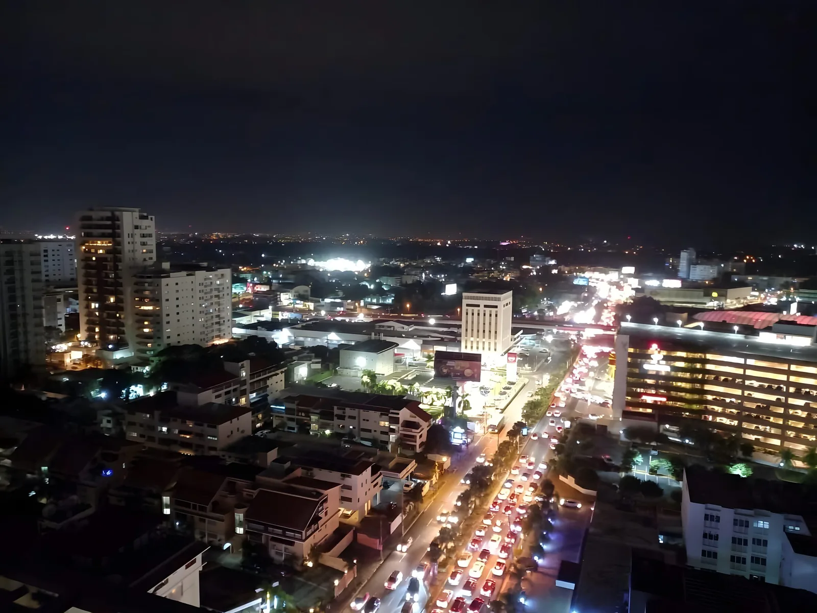 Night view from the apartment over the lit city and a busy avenue